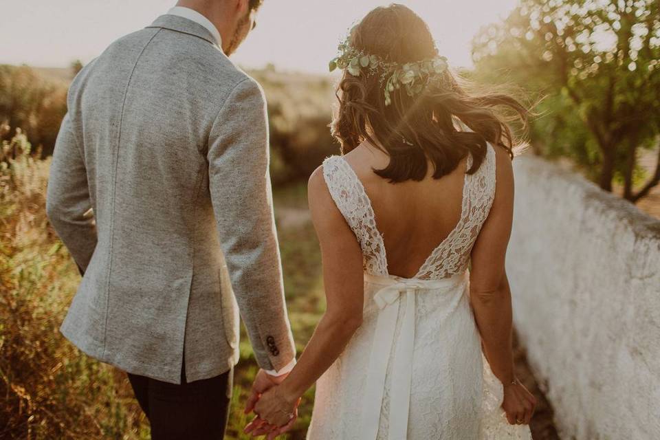 wedding couple holding hands and walking