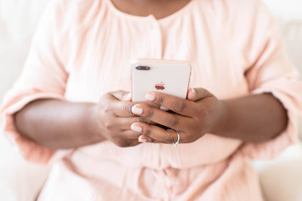 woman's hands holding an iphone