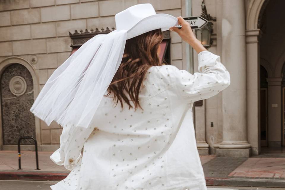 bride wearing white embellished denim jacket