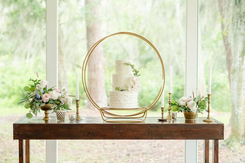 white wedding cake with hoop backdrop
