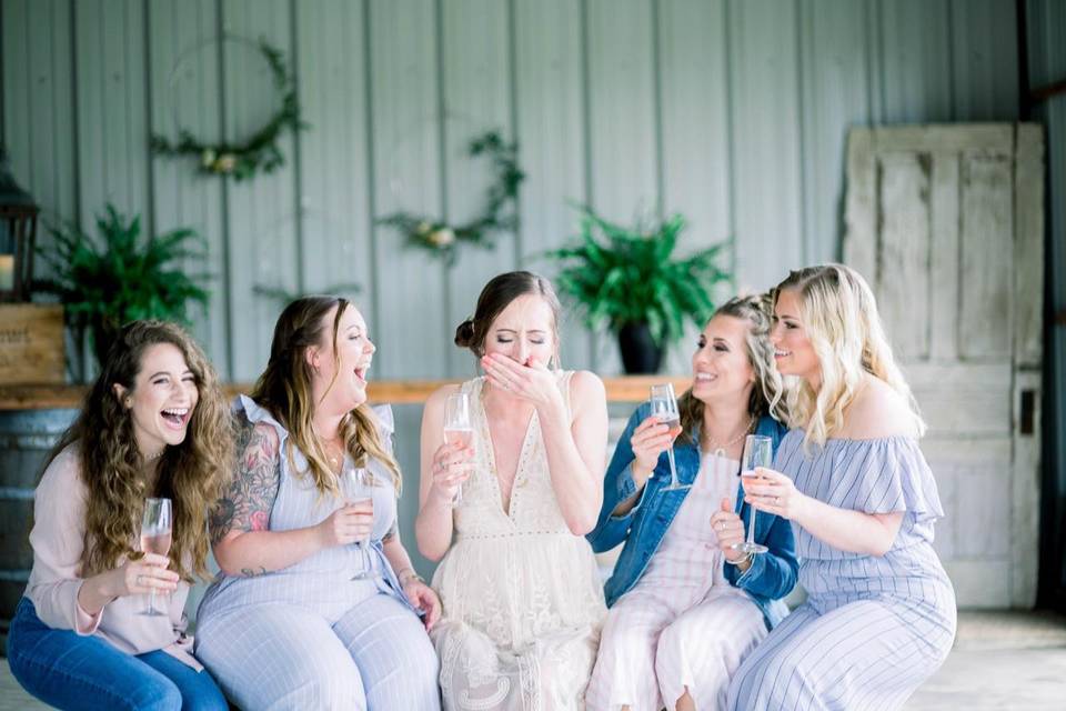 five women drinking champagne and laughing