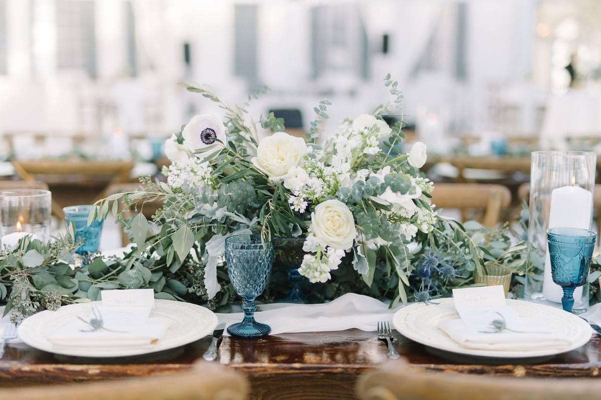 blue and white wedding tablescape with greenery centerpiece