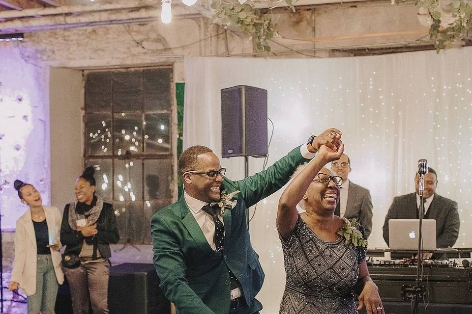 groom twirls his mom on the dance floor