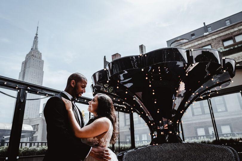bride and groom hugging with city backdrop