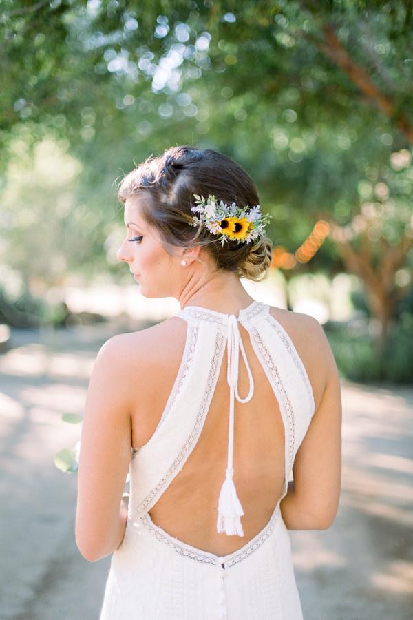 back of bride's hair low chignon with small sunflowers