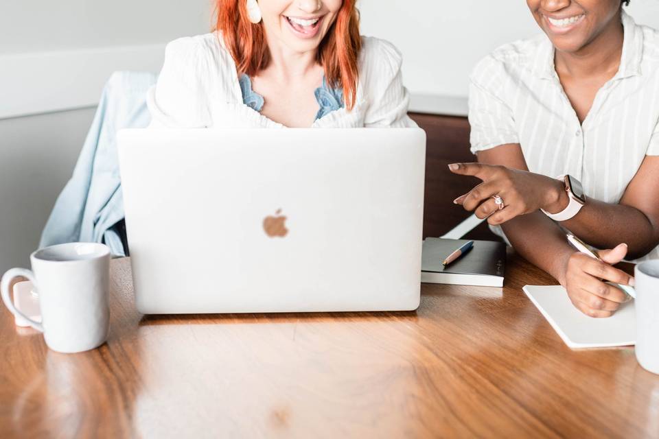 two women looking at computer