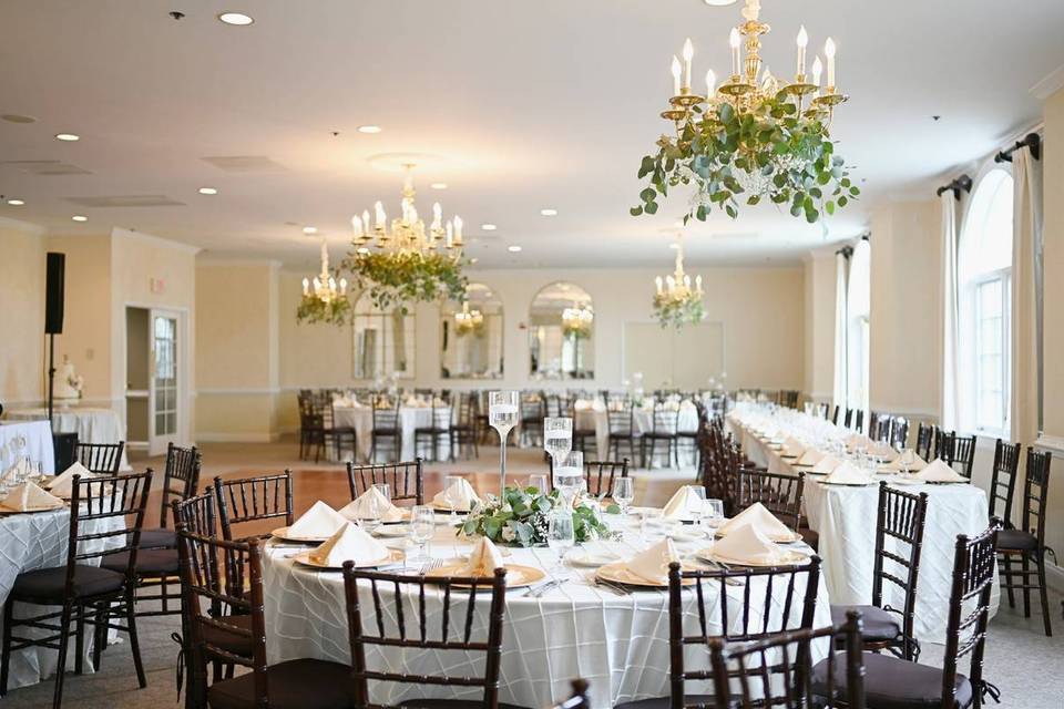 wedding reception room decoorated with greenery