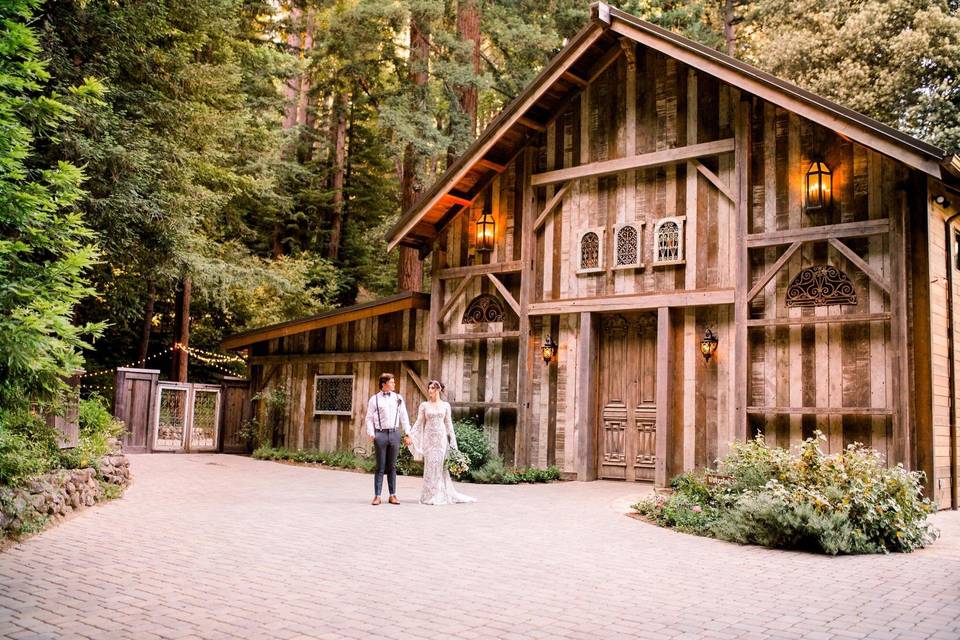 bride and groom holding hands outside of a cabin