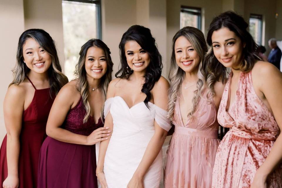 Bride and bridesmaids posing for a group photo