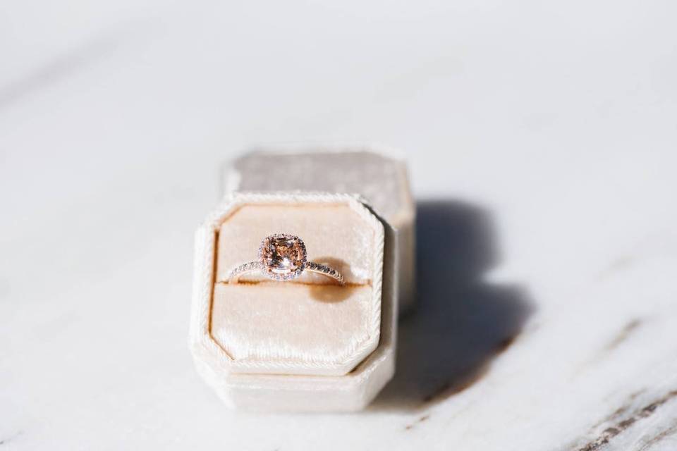 cushion-cut morganite engagement ring with halo setting in a pink velvet ring box
