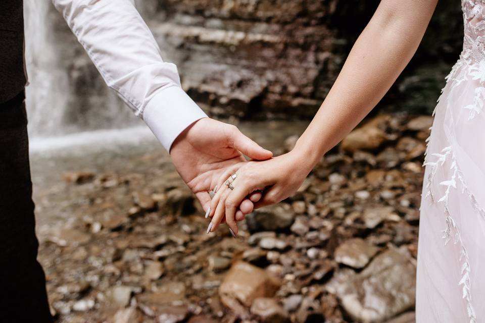 bride and groom holding hands