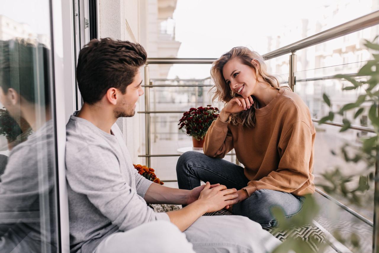 couple talking on balcony