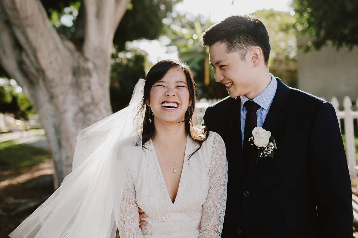 Asian bride and groom laugh candid wedding portrait