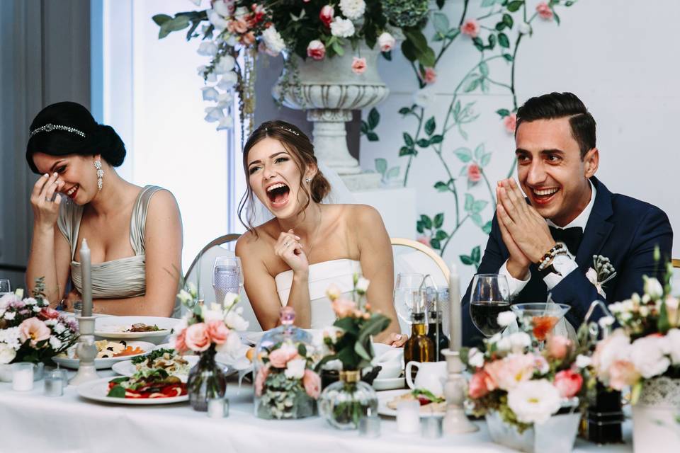 couple sitting at table and laughing