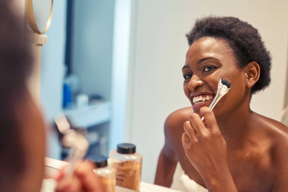 woman doing facial treatment in mirror