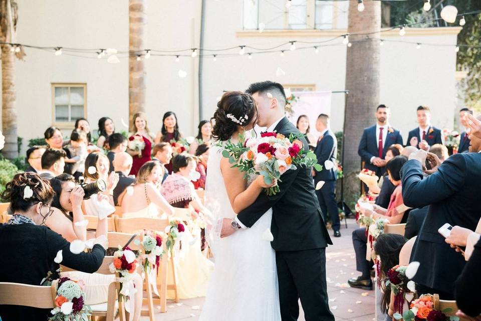 bride and groom kissing at wedding ceremony