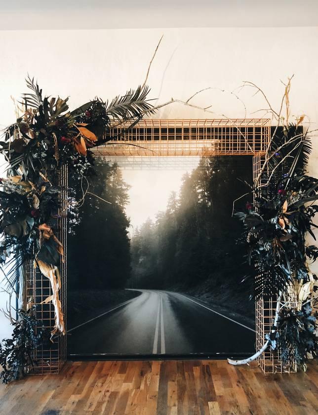 halloween themed wedding backdrop photo of deserted foggy road through a forest
