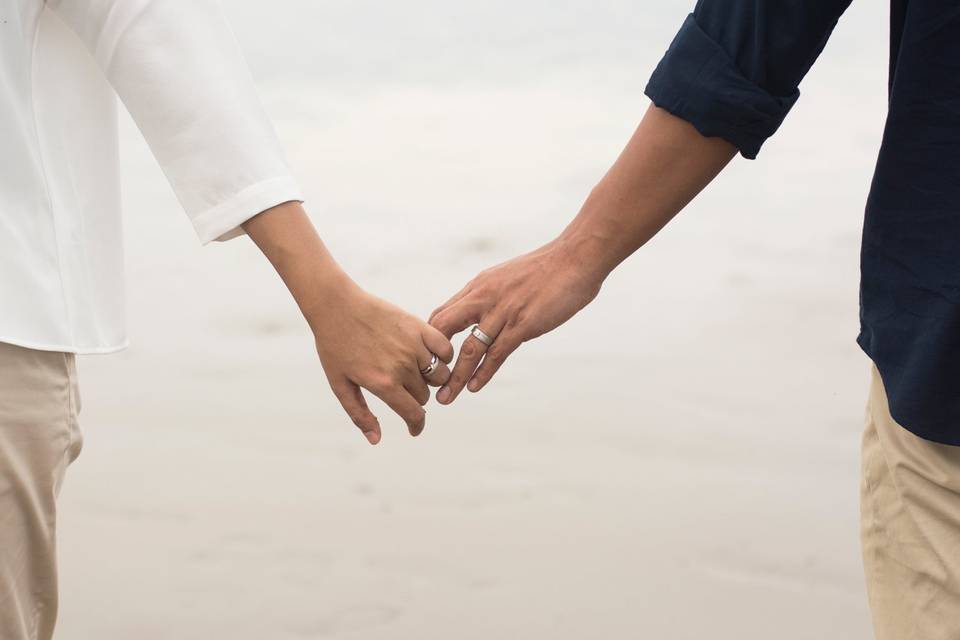 Engaged couple holding hands.