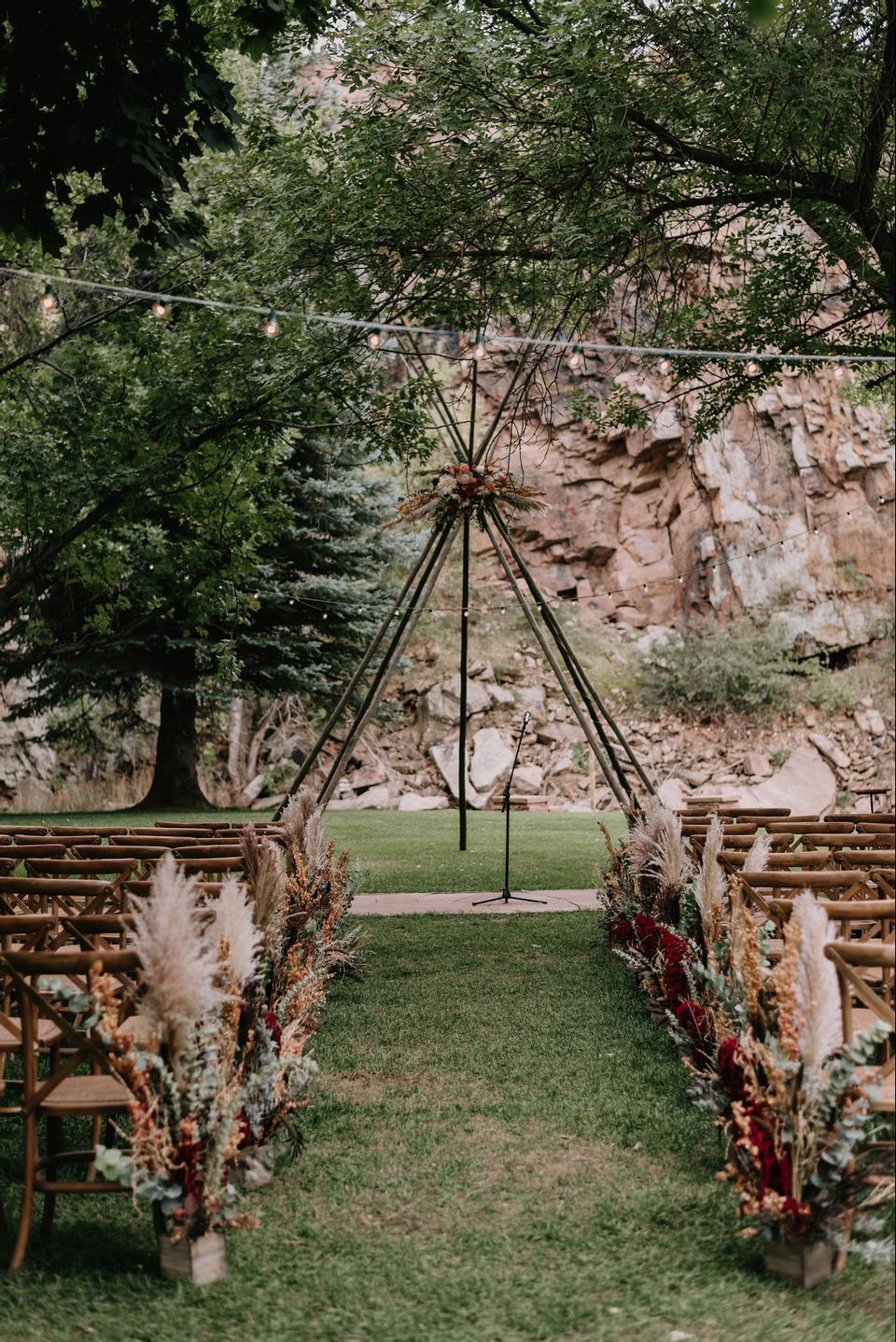 boho outdoor wedding aisle decor idea with pampas grass and greenery aisle markers