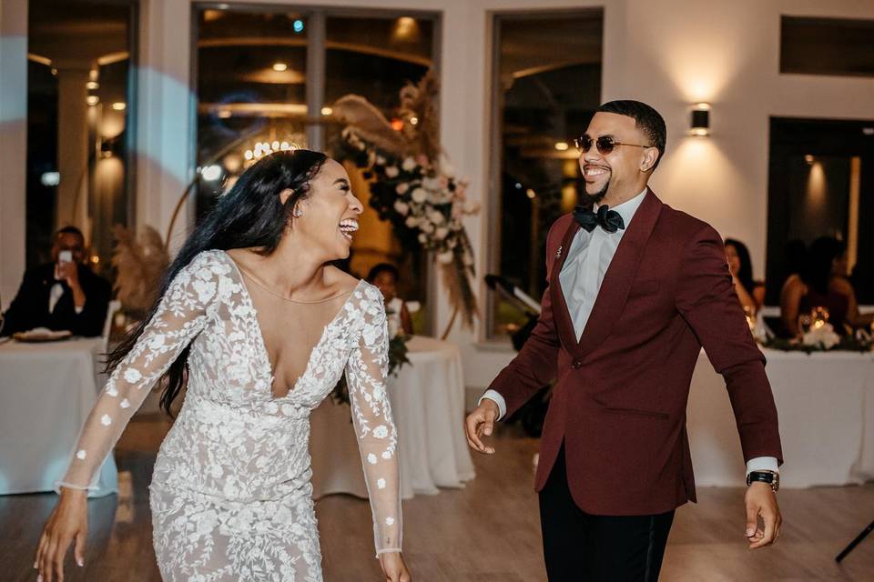 bride and groom laughing on the dance floor