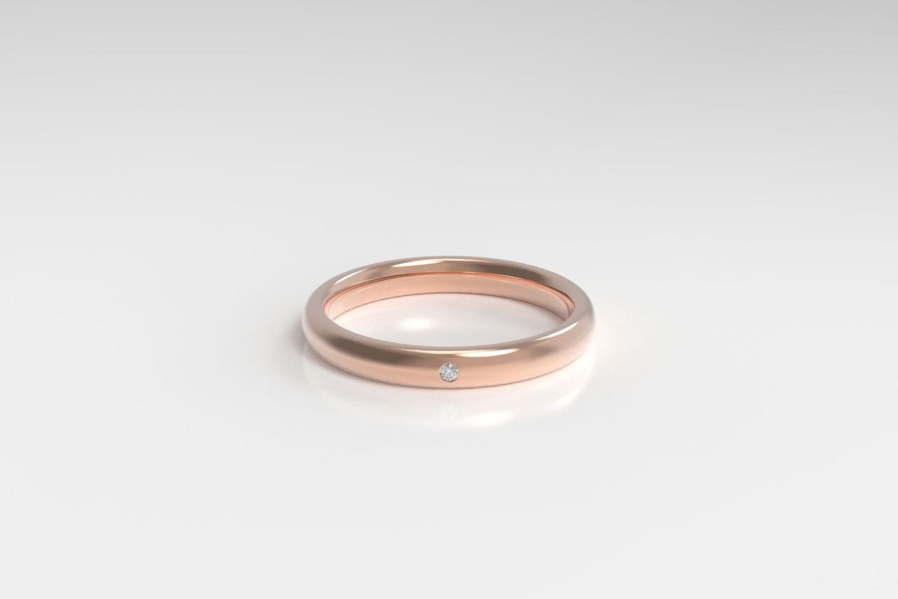 Minimalist rose gold band with small diamond accent