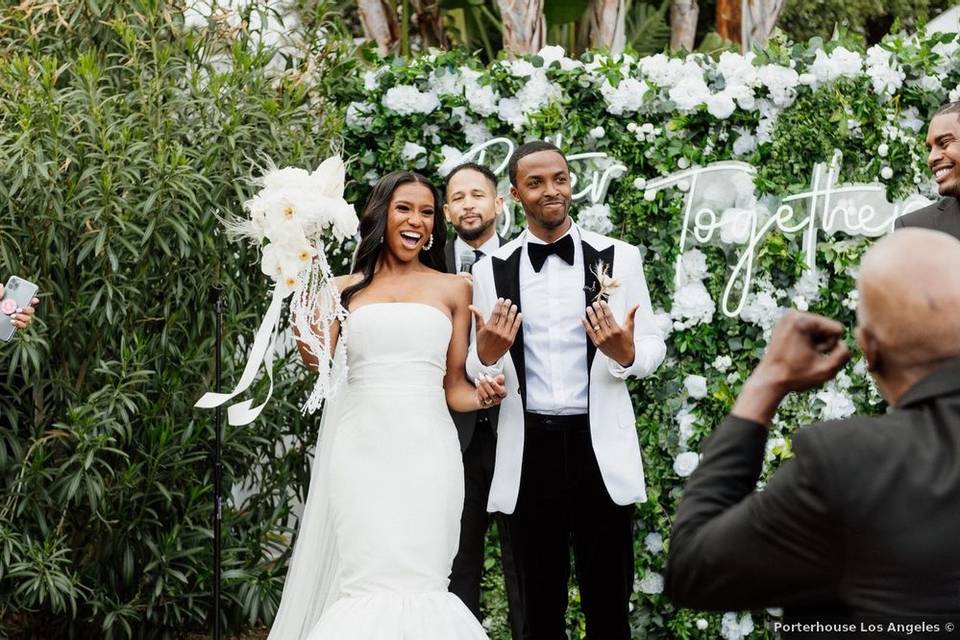 wedding couple cheering and celebrating after wedding ceremony