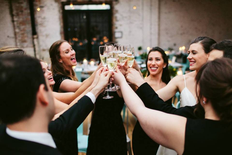 group of wedding partygoers toasting champagne
