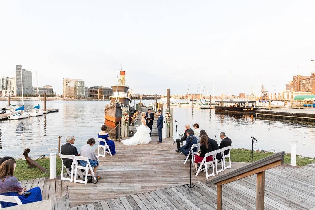 outdoor waterfront baltimore wedding venue overlooking inner harbor and city skyline with boats
