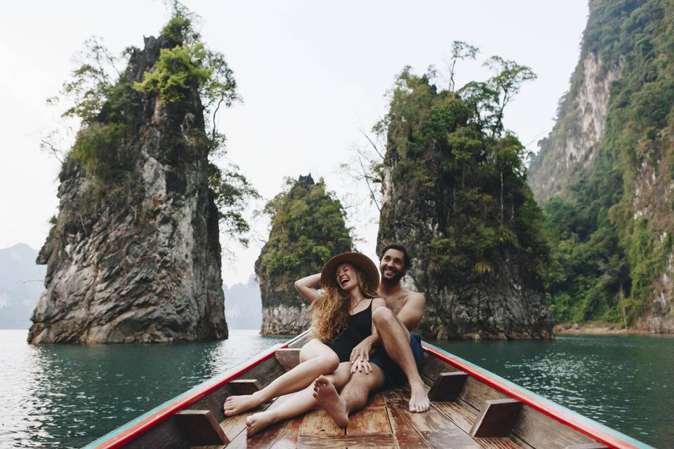 couple sitting on a boat with scenic surroundings