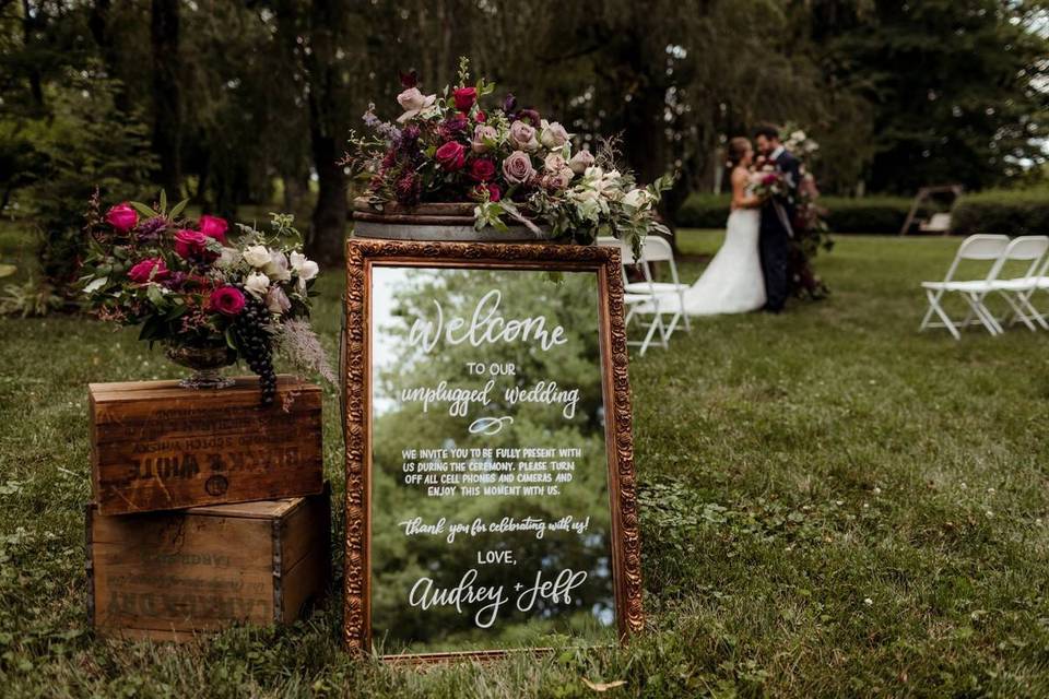 wedding ceremony with unplugged wedding mirror sign