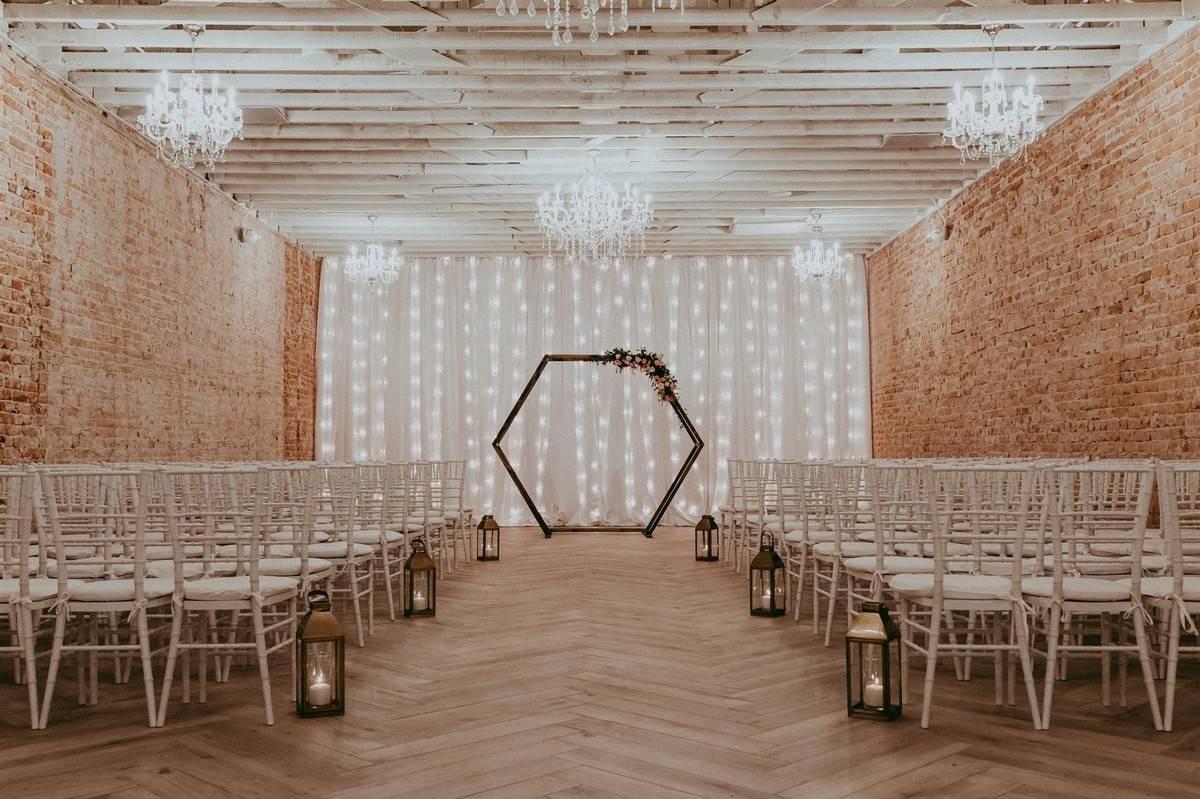 indoor industrial event space set up for wedding ceremony