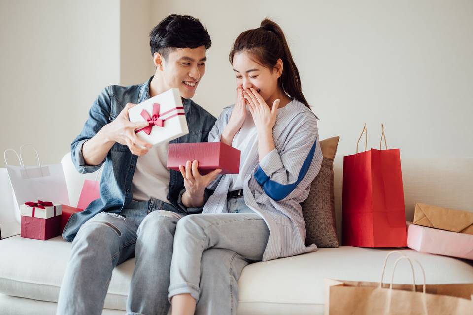 man presenting woman with gift