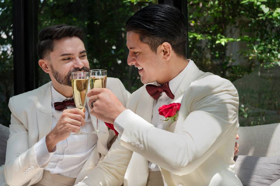 Gay newlywed couple toasting with champagne
