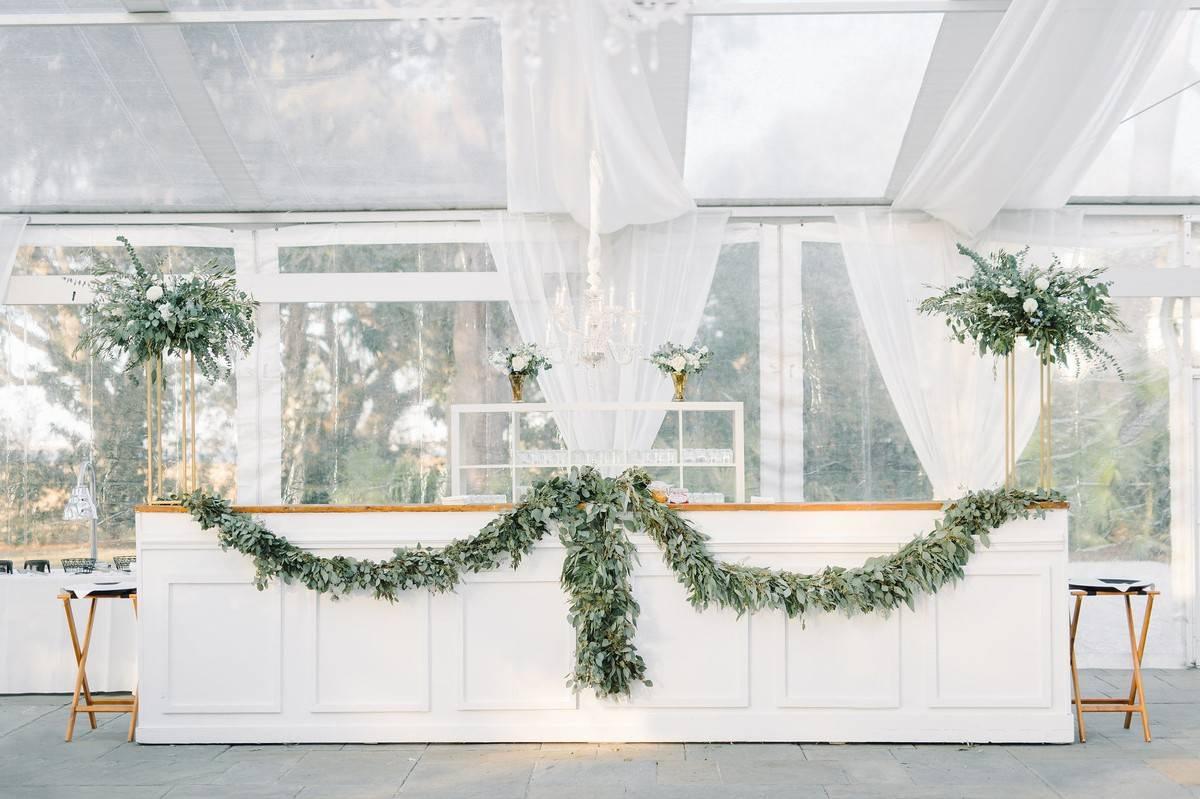 custom wedding bar decorated with eucalyptus greenery garland