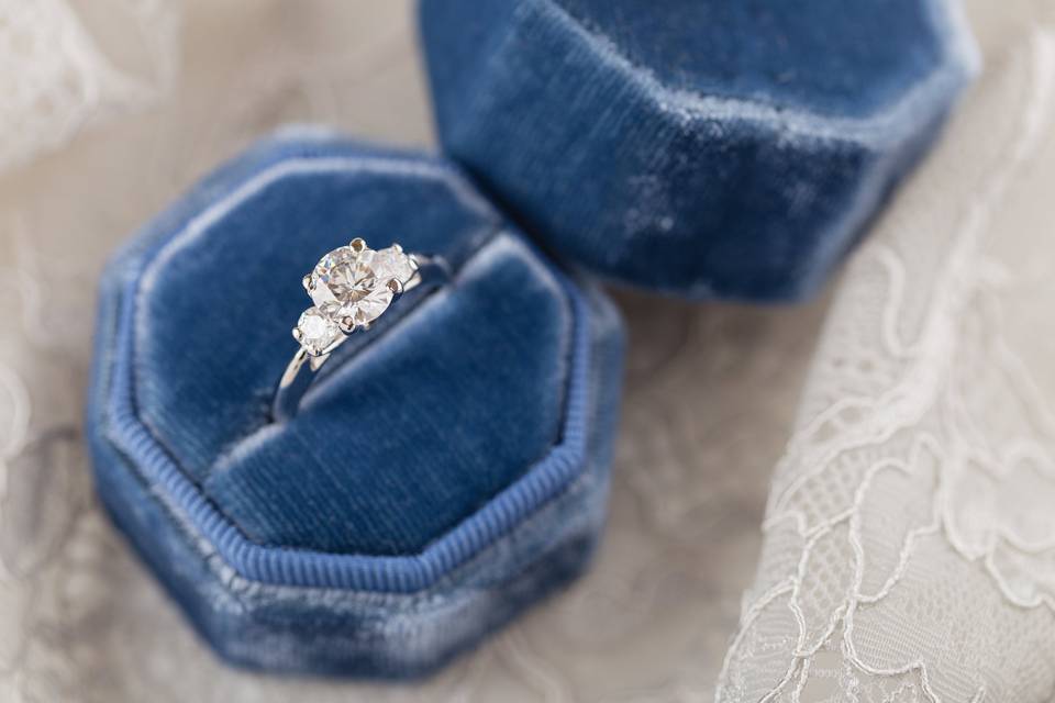 three stone engagement ring in blue velvet ring box