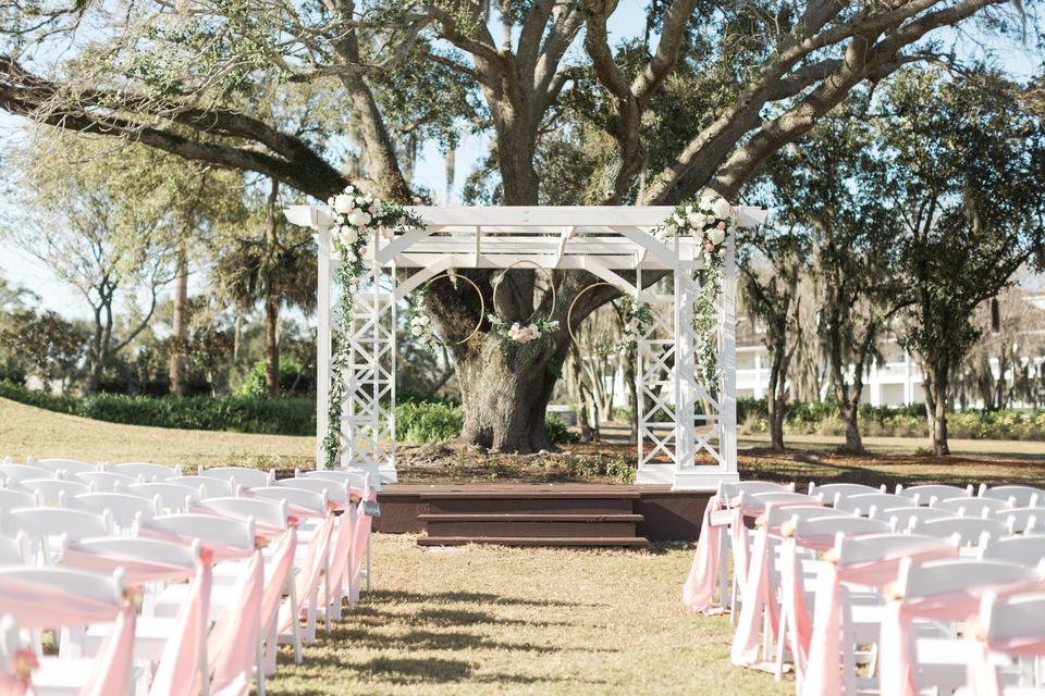 outdoor wedding aisle decor pink sashes tied around chairs along the aisle