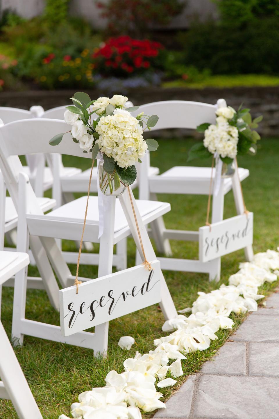 outdoor wedding aisle decor reserved seating signs with hydrangea and greenery aisle markers