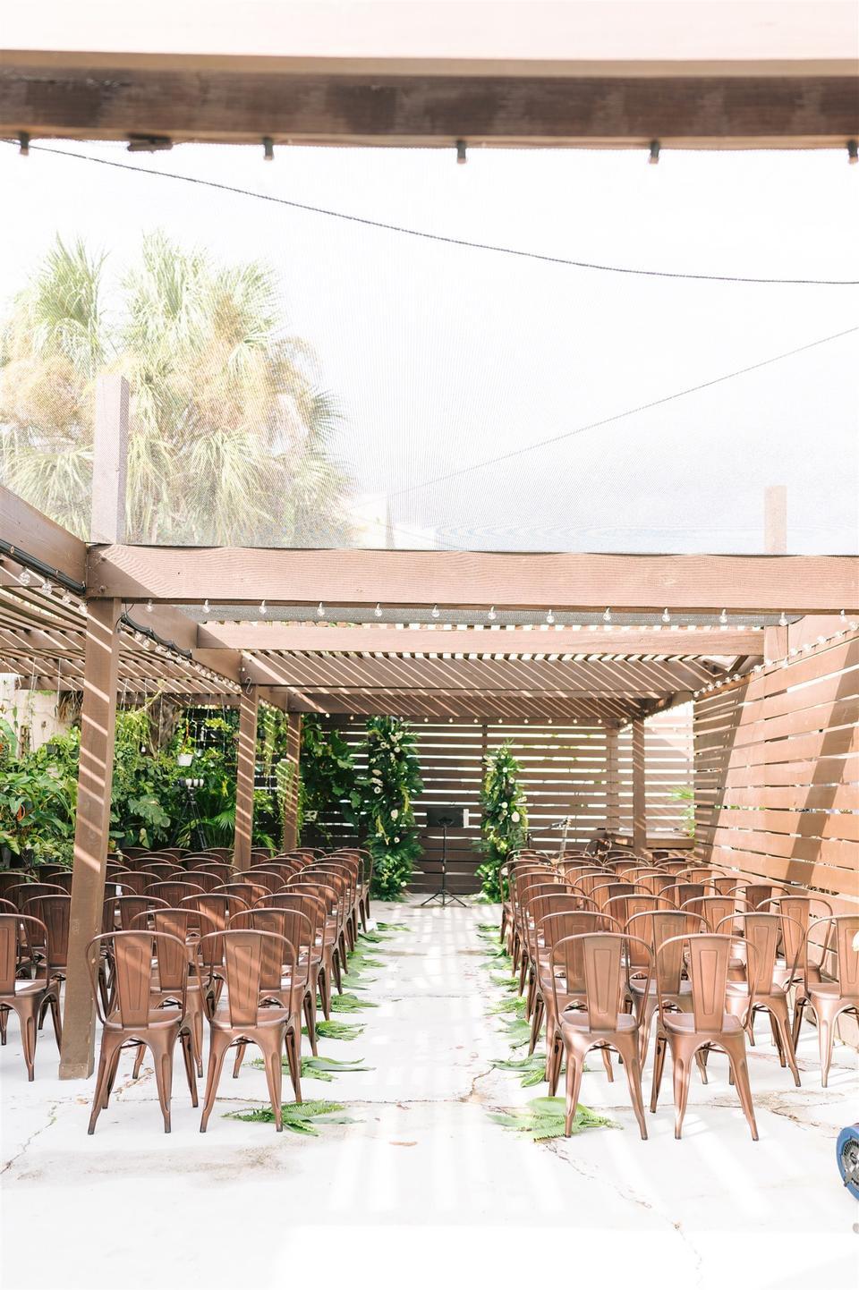 boho outdoor wedding aisle decor idea greenery palm leaves along the sides of the aisle