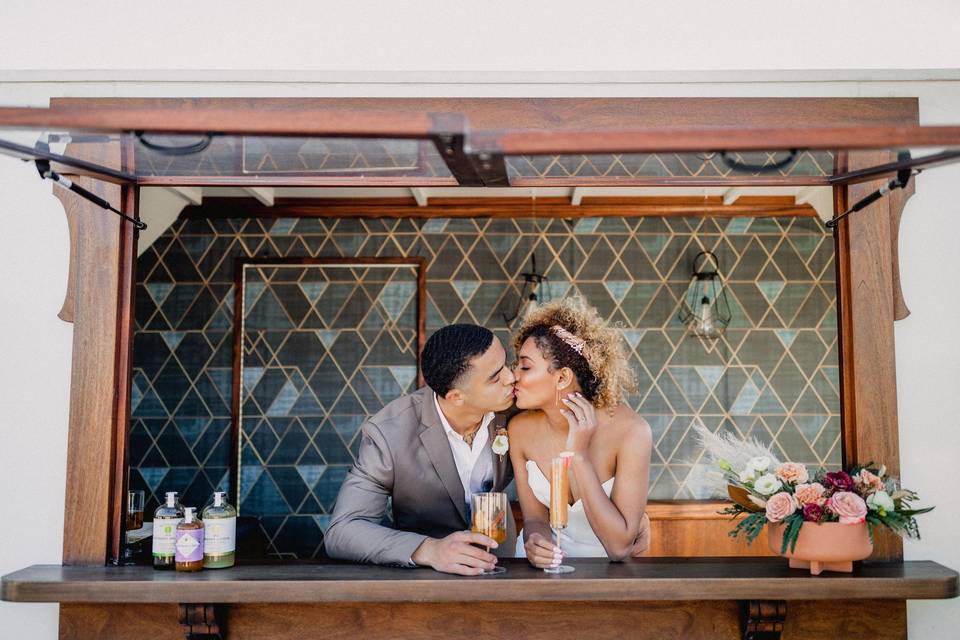 couple kissing in a mobile bar