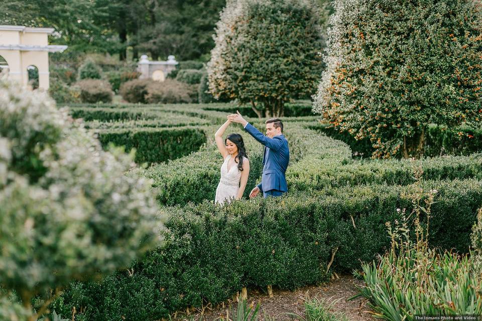 bride and groom twirling in outdoor garden