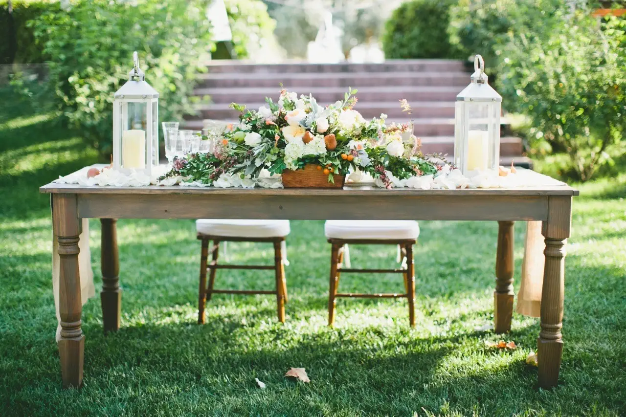 Wildflower nature wedding centerpieces with wood slices, bottles