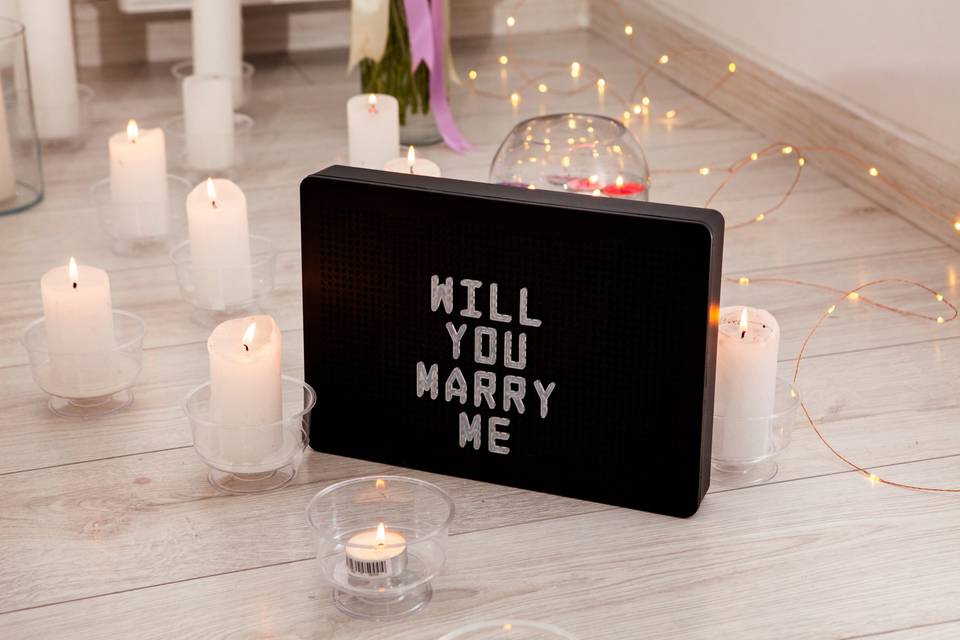 Proposal decorations and sign that reads Will You Marry Me