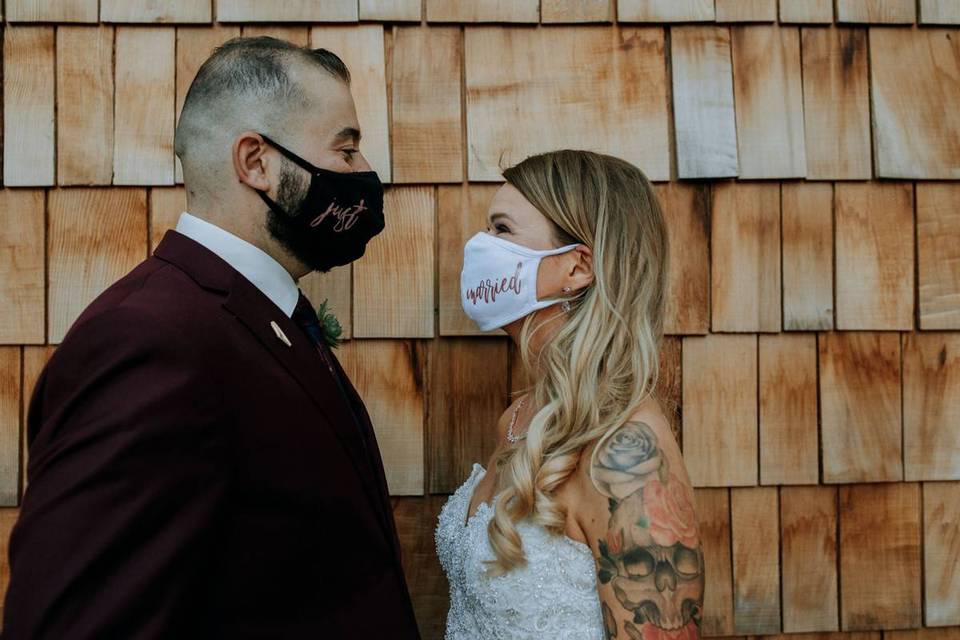 groom and bride wearing just married face masks