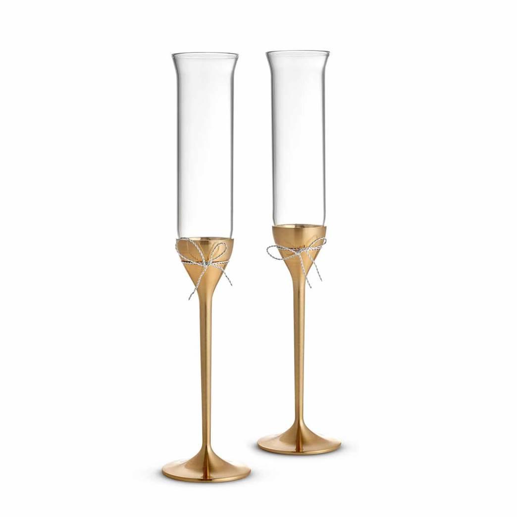 Gold-stemmed wedding champagne flutes with silver bows