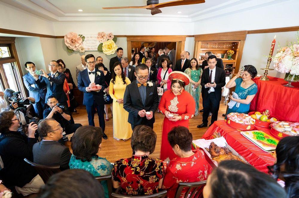 vietnamese-chinese wedding couple presenting tea cups to their parents