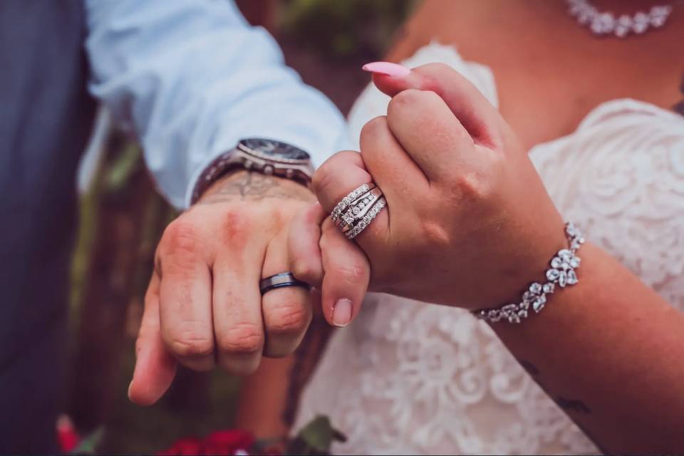 couple pinky swear with engagement rings