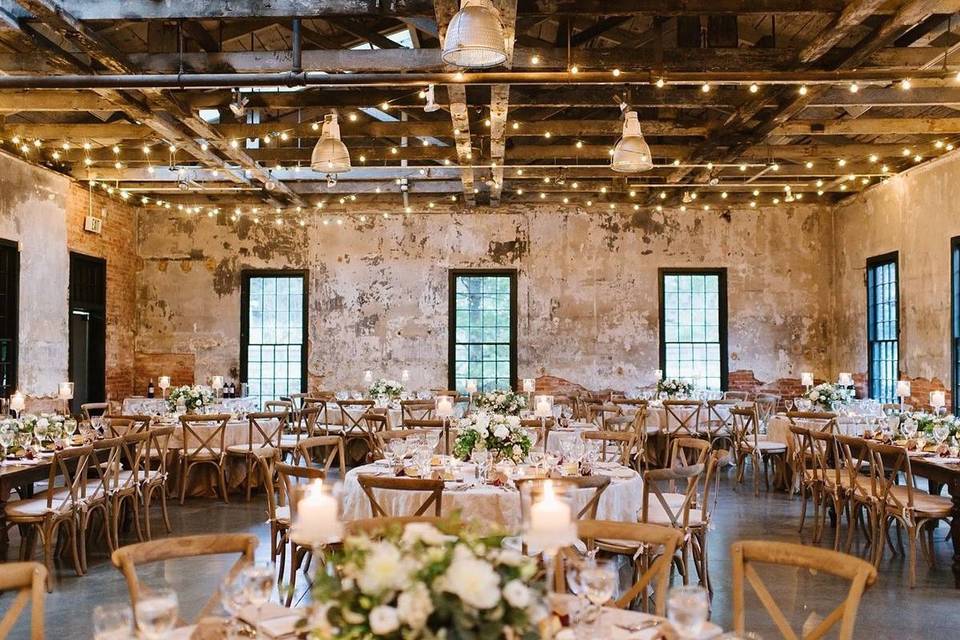 industrial baltimore wedding venue with distressed walls and exposed ceiling beams and string lights