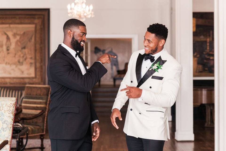 groom and his best man having candid conversation while getting ready