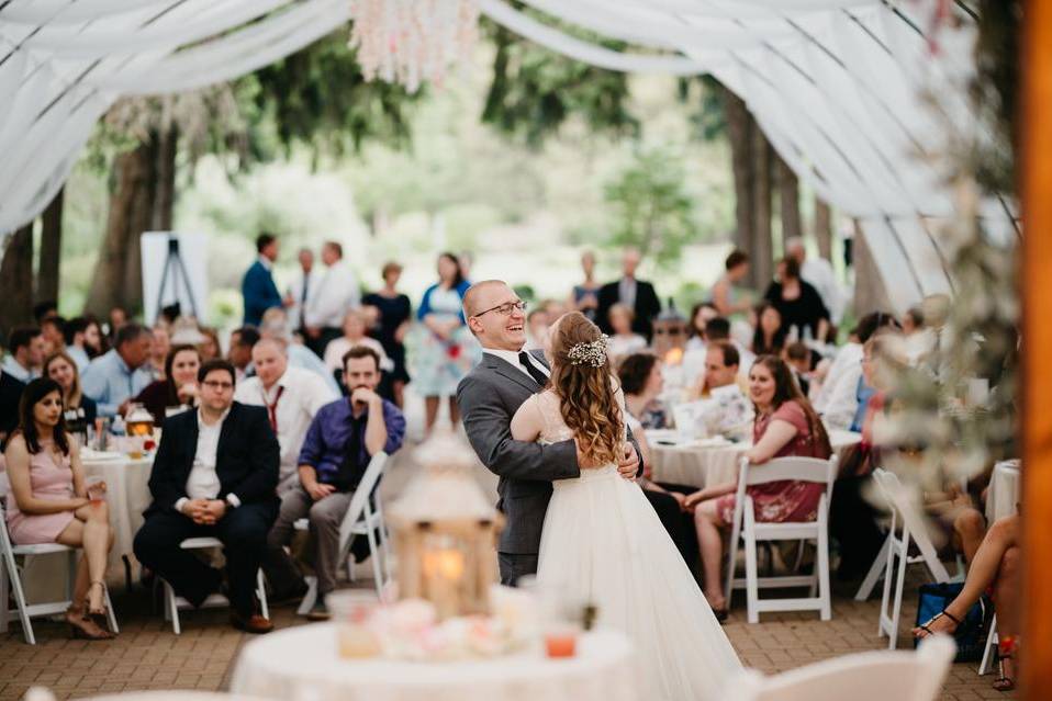 Bride and groom dancing in front of guests at spring wedding