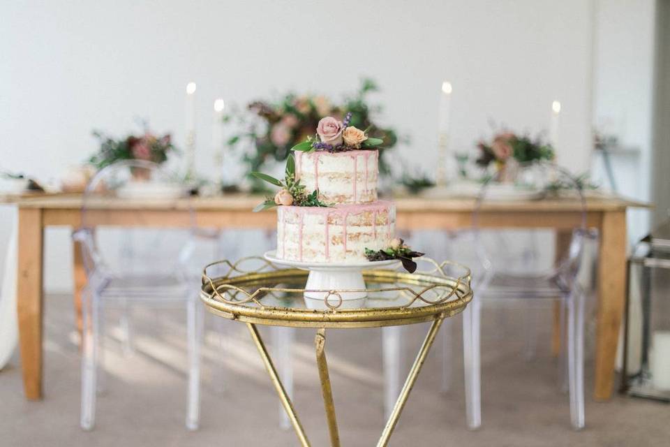 cake with pink drip icing and fresh flowers on top